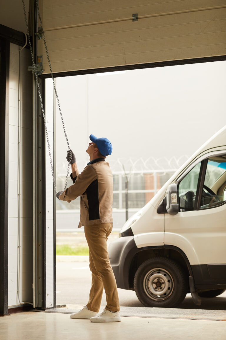 Handyman checking the manual opening for a garage door replacement.